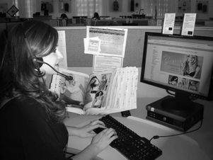 woman sitting at desk looking at computer screen