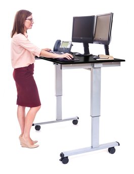 Woman standing at adjustable height desk